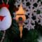 Handcrafted miniature wooden birdhouse ornament shaped like an icecicle with a pointed roof and base, featuring a rounded entrance hole and a perched bird, and made from reclaimed hardwoods finished with a satin shellac.