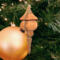 Handcrafted miniature wooden birdhouse ornament shaped like an icecicle with a pointed roof and base, featuring a rounded entrance hole and a perched bird, and made from reclaimed hardwoods finished with a satin shellac.