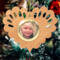 Wooden heart-shaped ornament with scalloped edges and an oak grain finish, featuring a removable round gold frame that holds a photo of a smiling blonde child.