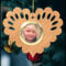Wooden heart-shaped ornament with scalloped edges and an oak grain finish, featuring a removable round gold frame that holds a photo of a smiling blonde child.