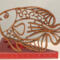 Handcrafted wooden tropical fish ornament made from 1/4-inch thick oak, finished with shellac, designed for holiday decor or year-round display as wall art.
