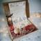 Handmade Dear Santa Letter Kit with cocoa cone, candy canes, crayons & reindeer food in festive box under soft Christmas lights.