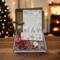 Handmade Dear Santa Letter Kit with candy canes, crayons, and cocoa cone, softly lit by fireplace glow and Christmas tree twinkle lights.
