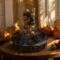 Artisan centerpiece crafted with pinecones and metallic ornaments in warm golden tones; perfect for seasonal home decorating.