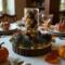 Close-up of handmade centerpiece with pinecones, greenery, and metallic ornaments; warm rustic decor for table or mantel.