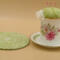 This shows the trivet next to the pincushion bobbin holder. It measures approximately 5.5 inches around.
