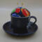Looking at the front of the pincushion/bobbin holder, it's easy to see the lace on the mug and the colors of the flower of the pincushion.