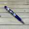 Blue and chrome pen woth DnD postage stamps cast in clear resin 
