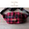 Red and black buffalo plaid wool hunting belt bag handcrafted from Johnson Woolen Mills fabric lays in natural light - ideal for hunters.