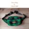 Green and black buffalo plaid wool hunting belt bag handcrafted from Johnson Woolen Mills fabric lays in natural light - ideal for hunters.