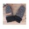 Handmade speckled black and white baby mittens with black ribbed cuffs, made from soft fleece; cozy thumbless winter mittens for infants.