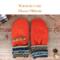 Pair of warm and cozy orange fleece baby mittens with patterned cuffs; thumbless winter mittens for babies and toddlers.