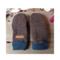 Pair of handmade women’s brown fleece mittens with navy cuffs and leather warmth tag, displayed flat on rustic wood background.