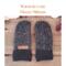 Pair of warm and cozy black and white speckled fleece regular sized women's mittens on rustic wood background — winter mittens for woman.