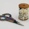 This view shows the 2 inch high wooden spool and her embellishment, The multicolored scissors are 4 inches long and included.