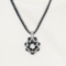Black and white beaded pendant necklace featuring circular geometric pattern.