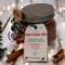 Christmas Hot Cocoa Jar with cinnamon sticks and pine decor, festive handmade cocoa mix gift idea.