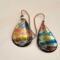 Handmade flame-colored copper teardrop earrings sealed with UV resin and handcrafted copper ear wires.