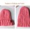A hand knit hat featuring wool yarn in pink ribbing. Perfect for gifting, this stretchy hat suits adults and teens.