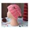 A hand knit wool beanie in solid pink features a stretchy, ribbed stitch pattern. Ideal for adults and teens, made from soft Turkish yarn.