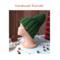 A hand knit green acrylic hat styled. Rich cozy ribbed stitches provide warmth and stretch. Perfect as a holiday gift for kids ages 10 to 14