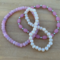 This is a set of three stretch bracelets, some beads are round and some are oval/ they are cream and pink.