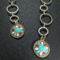This is a pair of handmade western dangle earrings.