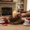 Handmade rustic wood slice candle centerpiece being styled with pine greenery and red heart Valentine decor