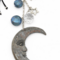 Close-up of moon pendant with crystal and star charm