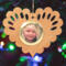 Wooden heart-shaped ornament with scalloped edges and an oak grain finish, featuring a removable round gold frame that holds a photo of a smiling blonde child.