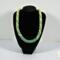 Verdant Fade Kumihimo Necklace displayed on a black bust stand, showing overall shape, proportions, and green fade pattern