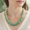 Verdant Fade Kumihimo Necklace by Bead & Braid Collective worn by a model, green ombré beaded necklace showing natural drape