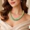 Close-up view of Verdant Fade Kumihimo Necklace on a model, highlighting green beaded braid and subtle color transition