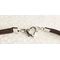 Brown suede attached to heart clasp.