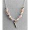Elegant clear and pink glass beads with silver tone spacers  placed on a silver plated chain with a 3D flute pendant charm.