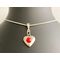 A dainty puff heart with a red crystals, silver bail, and silver plated chain.  This is  beautiful for a  young musicians birthday.