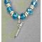Elegant turquoise glass beads with double silver tone spacers  placed on a silver plated chain with a 3D flute pendant charm. held by a silver bail.  A lovely gift for all ages and handmade.