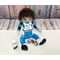 21 inch fully handmade cloth boy doll in light tan skin tone with dark brown hair and brown eyes. Wearing a blue and white racing jersey with matching riding pants, motocross boots and chest protector. Has magnetic bottle, pacifier, and toy dirtbike