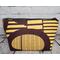 Back of a golden yellow and brown abstract African print large makeup bag featuring a gunmetal zipper .