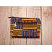 Front view of  a golden yellow, green and blue zippered medium sized makeup pouch