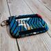 front view of a blue red and gold african print ID wallet with a clear ID window and a Bass Creations logo