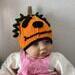pumpkin hat shown on baby