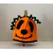 orange pumpkin hat with black facial features and green tendrils