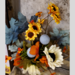 Floral arrangement with yellow sunflowers and orange bittersweet
