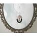 Black copper enamel hoop earrings with dangling tree inside hoop