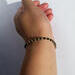 Person models the bracelet on their wrist.  Photo taken showing the beaded bracelet from the side of the arm, wrist, and hand.