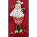 Santa dressed in partial different attire.  The newest rage is to wear elf leggings and slippers with pom poms.  The oval wood plaque measures  8" x 5" and display a holiday greeting.  This edition of Santa is available on red or green base, hat colors of red and white both with gold snowflakes.  Designed and handcrafted by Flute Emporium.