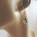 green mystic quartz earrings in ear