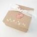 Photo of draft color gift box with muslin ribbon and copper charm, included in sale