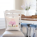welcome spring flowering tree pillow cover on a dining room chair